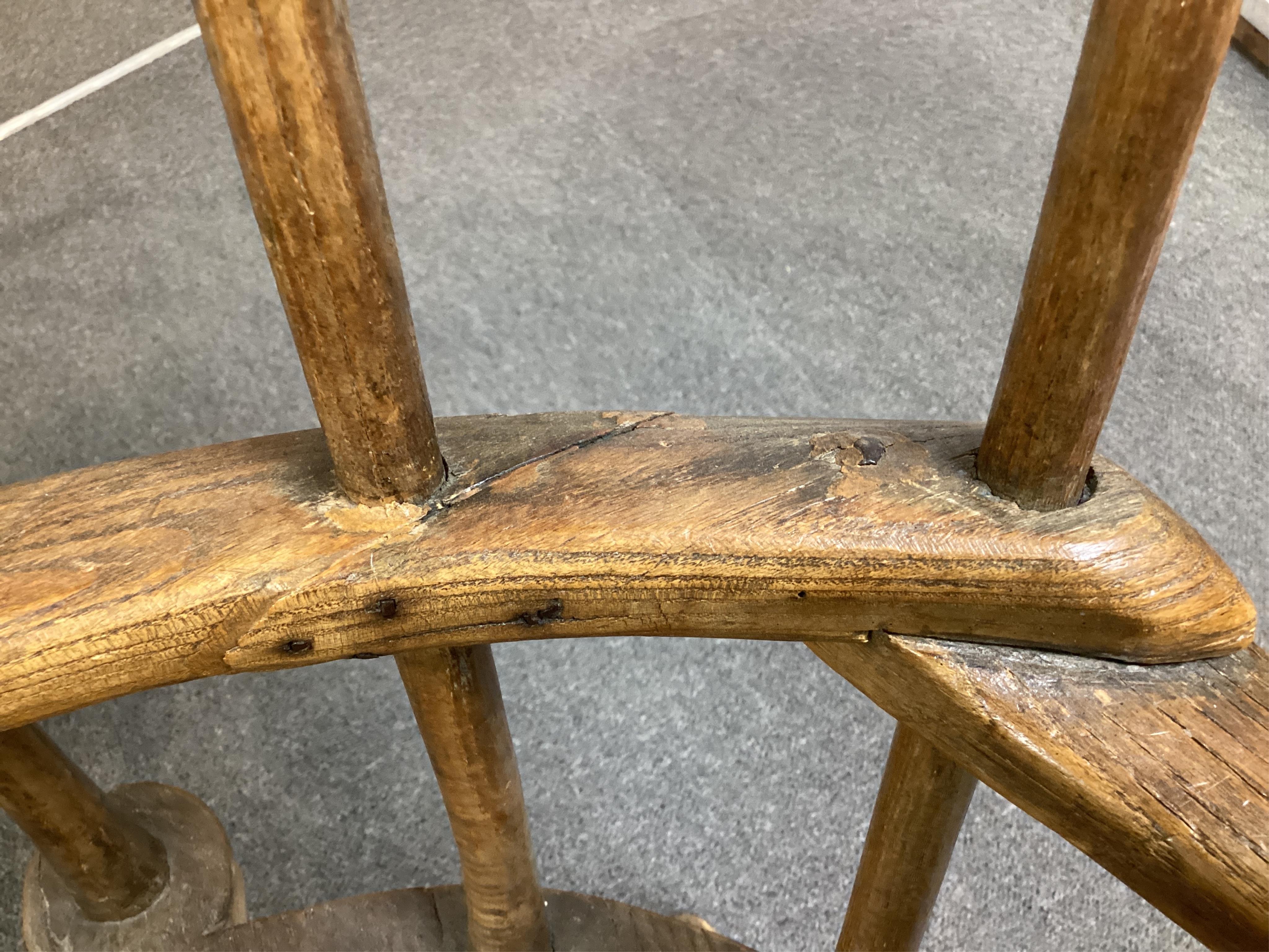 An 18th or 19th century primitive ash and elm Windsor armchair